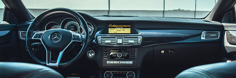 black car steering wheel and windshield view